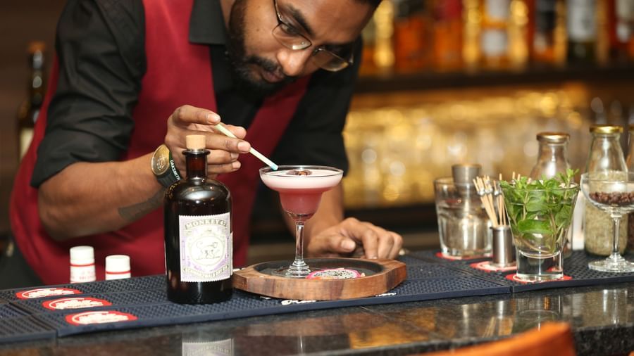 A bartender preparing a cocktail at the bar in The Citi Residenci Hotel, Durgapur.