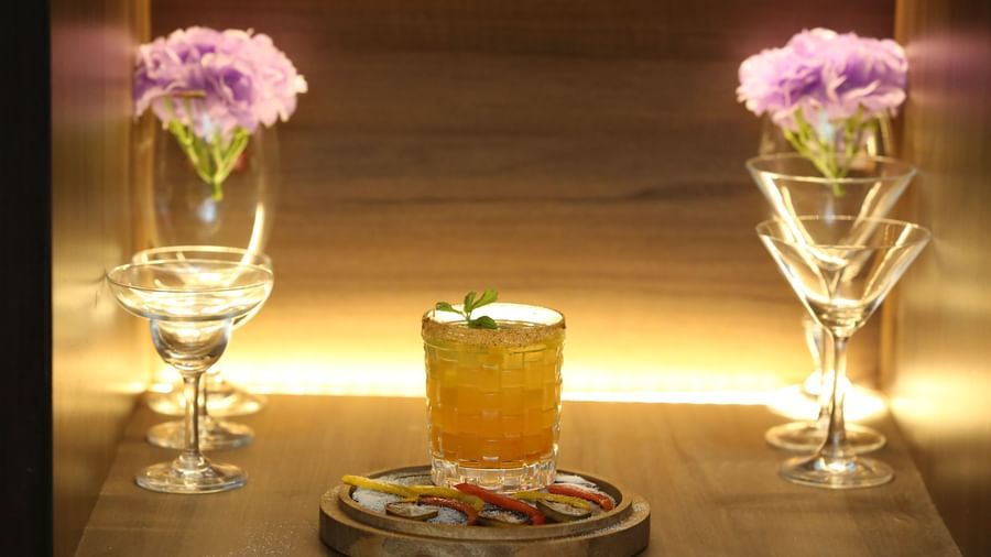 Elegantly arranged drinks and flowers on a table at The Citi Residenci Hotel, Durgapur.