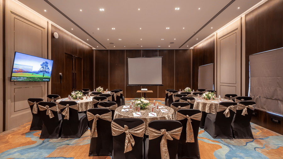 Banquet hall and meeting space with professional lighting and carpeted flooring at The Citrine, Bangalore.