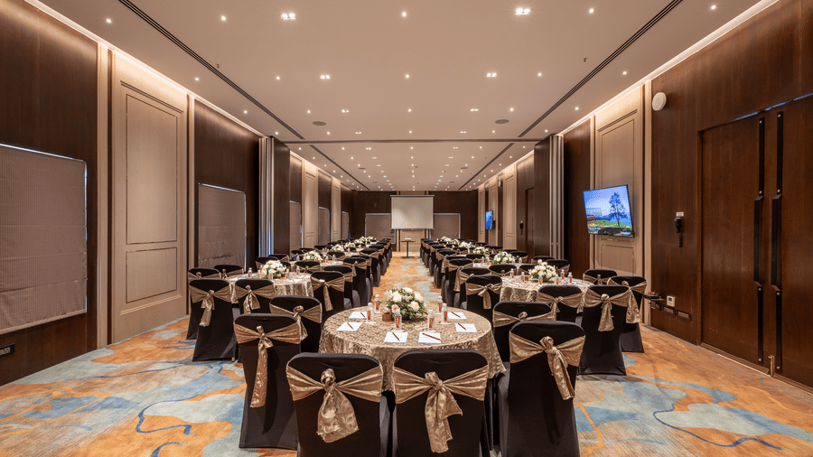 Wide shot of banquet hall and meeting space with professional lighting and carpeted flooring at The Citrine, Bangalore.