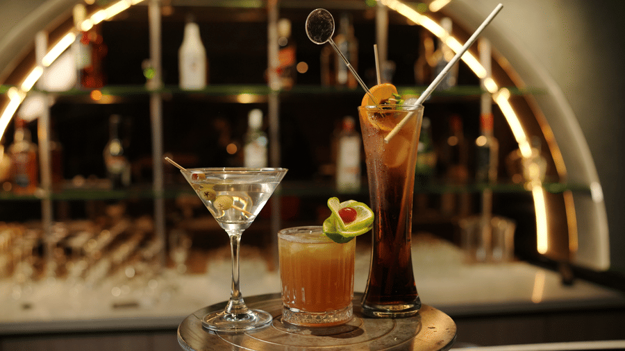 Citrine Hotel | Different sized glasses placed on a table with drinks in it.