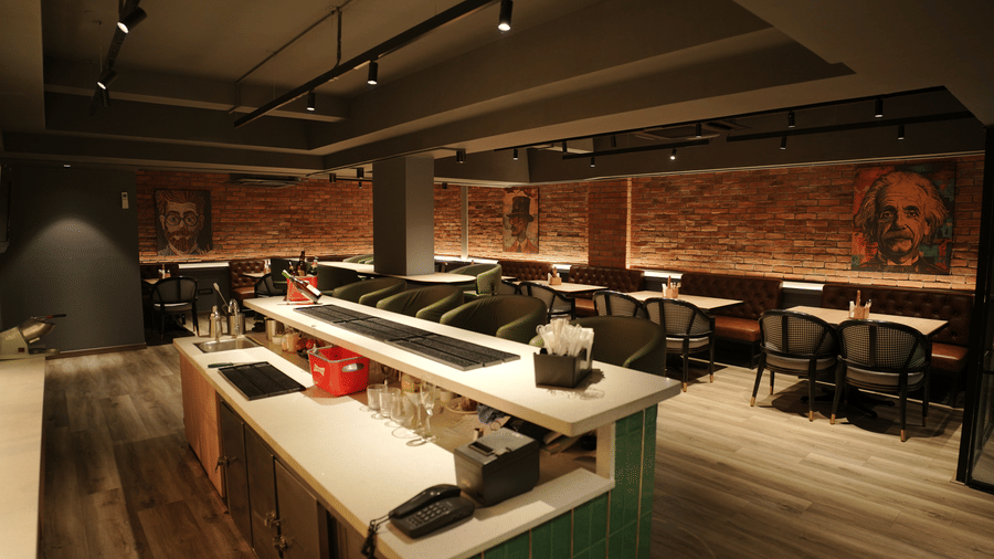 Citrine Hotel | A bar seating area with chairs, tables and counter at the corner.