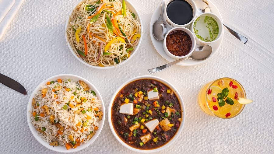 An assortment of Chinese dishes including noodles, fried rice, and a flavorful vegetable curry.