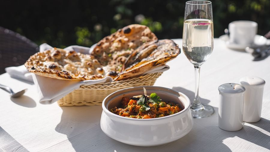 image of Indian bread complimented with a side dish along with a champagne glass