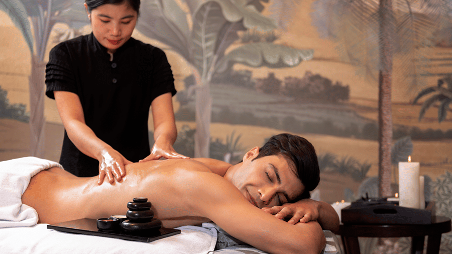 image of a man enjoying a back massage at the sumaya spa - The Claridges New Delhi