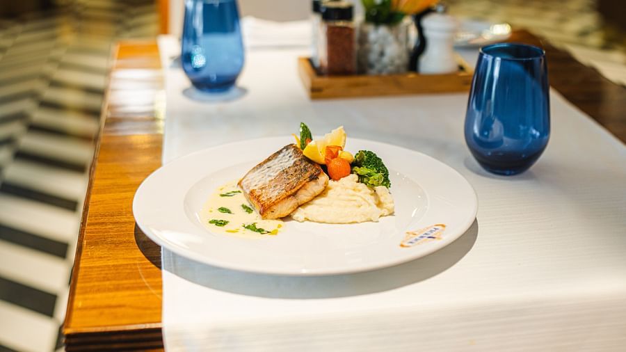 Image featuring a gourmet seafood dish elegantly plated on a fine dining table setting