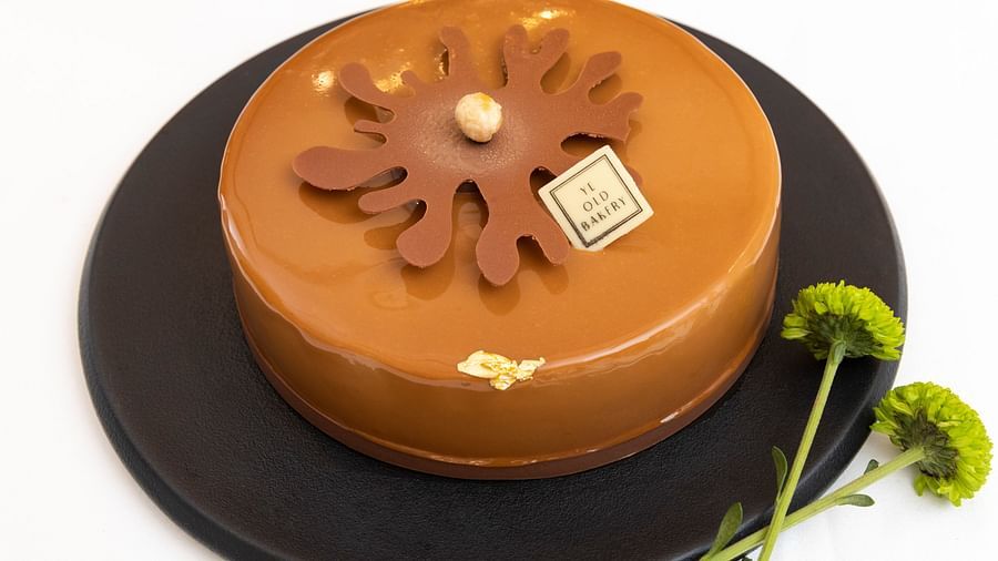 image of a hazelnut praline cake that is round in shape served at the ye old bakery - The Claridges New Delhi