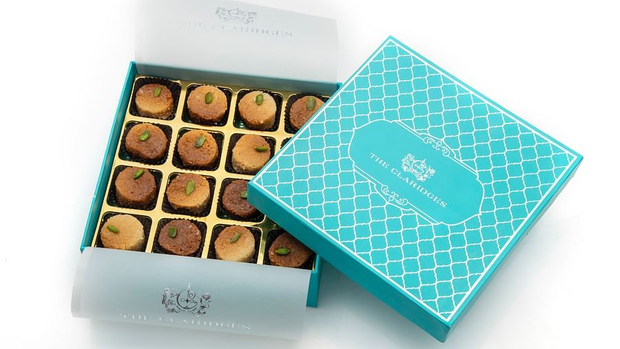 image of a sky blue coloured box with sixteen pieces of milk cake by the ye old bakery - The Claridges New Delhi