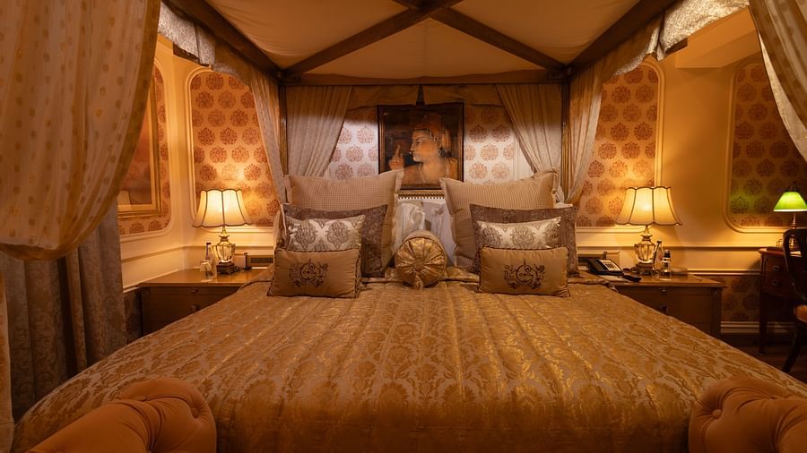 A front view of the Heritage Parlour Suite bed, adorned with a Mughal style painting elegantly positioned on the wall behind the headboard - The Claridges New Delhi