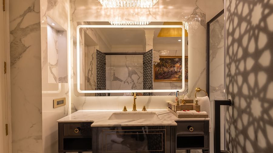 image of the attached bathroom of the heritage room focusing on the wide mirror with border lighting - The Claridges New Delhi