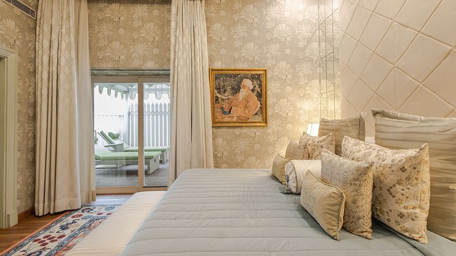 image of the bedroom from the side angle with french windows at our heritage luxury suite - The Claridges New Delhi