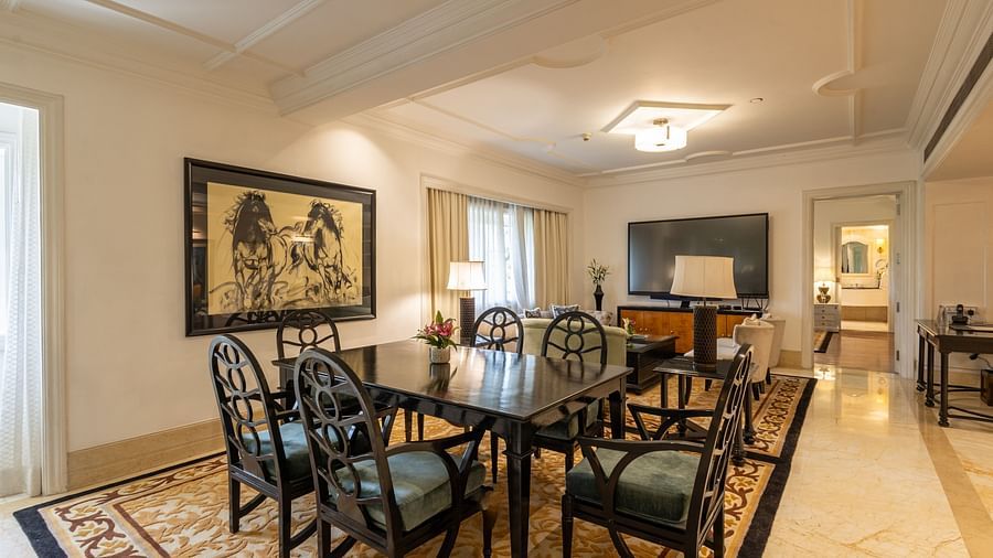 image of the living area with the dining table from a corner angle at the viceroy house estate suite - The Claridges New Delhi