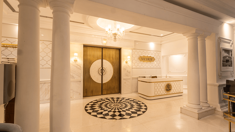 Image featuring the Viceroy Hall event venue at The Claridges New Delhi, showcasing the doorway, reception in the corner, and an elegant chandelier hanging