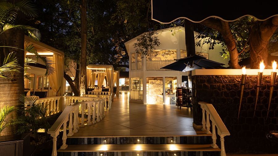 Sevilla restaurant entrance at The Claridges New Delhi, beautifully illuminated at night, showcasing its charming alfresco and indoor dining spaces