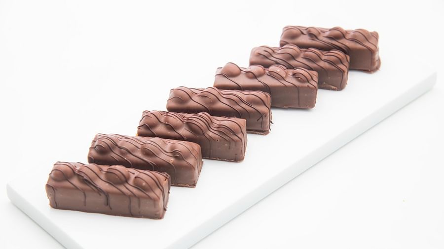 image of a plate lined up with snicker chocolate by the ye old bakery - The Claridges New Delhi