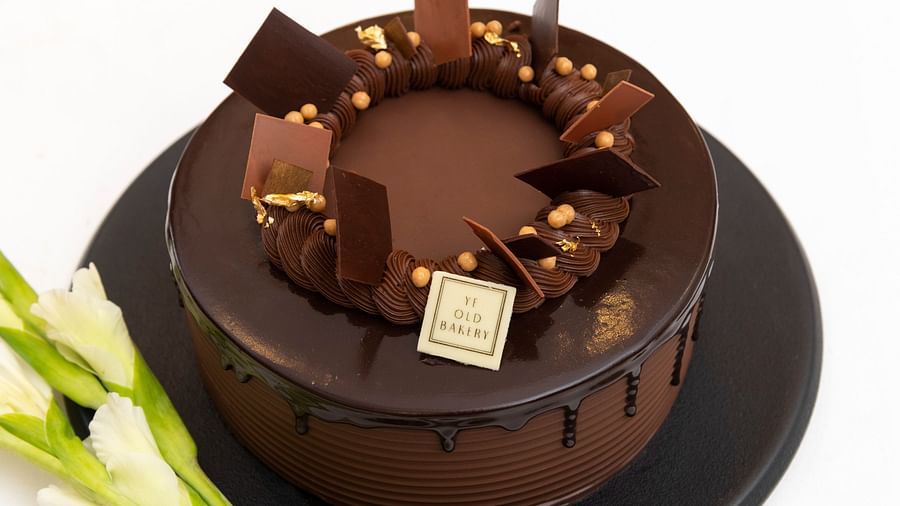 image of a chocolate truffle cake with chocolate ganache dripping from the side by the ye old bakery - The Claridges New Delhi