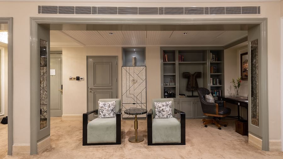 image of two chairs places in the middle with a small coffee table between them - The Claridges New Delhi