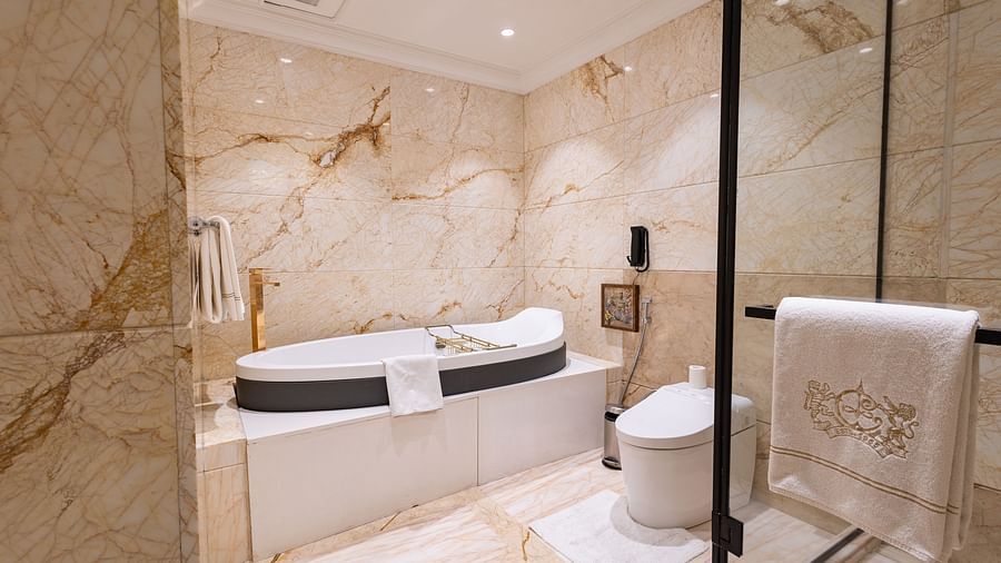 image of a modern bathtub in a well appointed bathroom at the willingdon crescent suite - The Claridges New Delhi