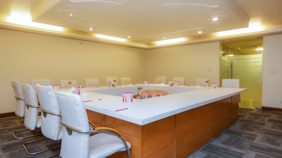 A spacious meeting room with a U-shaped table setup, perfect for collaborative work at The Conway, Meerut.