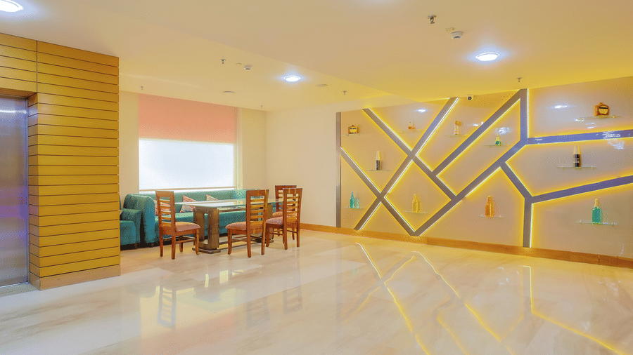 A modern restaurant space featuring unique geometric wall art and comfortable dining chairs at The Conway, Meerut.