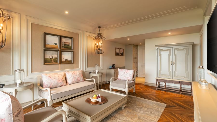 A wide-angle shot of the spacious living room at the Evren Suite featuring a beautiful couch set along with a coffee table in front of it at The Evren, Vagator.