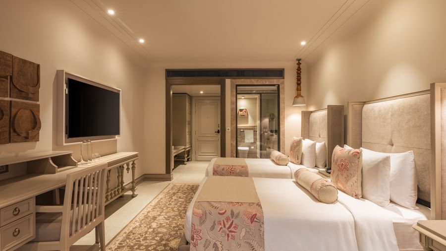 Side-view shot of the Premium Room featuring a twin bed with bright interiors at The Evren, Vagator.