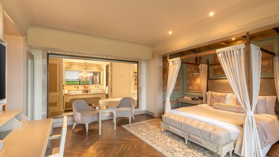 Side-view of the bedroom at the Evren Suite featuring a double bed along with a huge glass partition separating the bedroom with the bathroom at The Evren, Vagator.