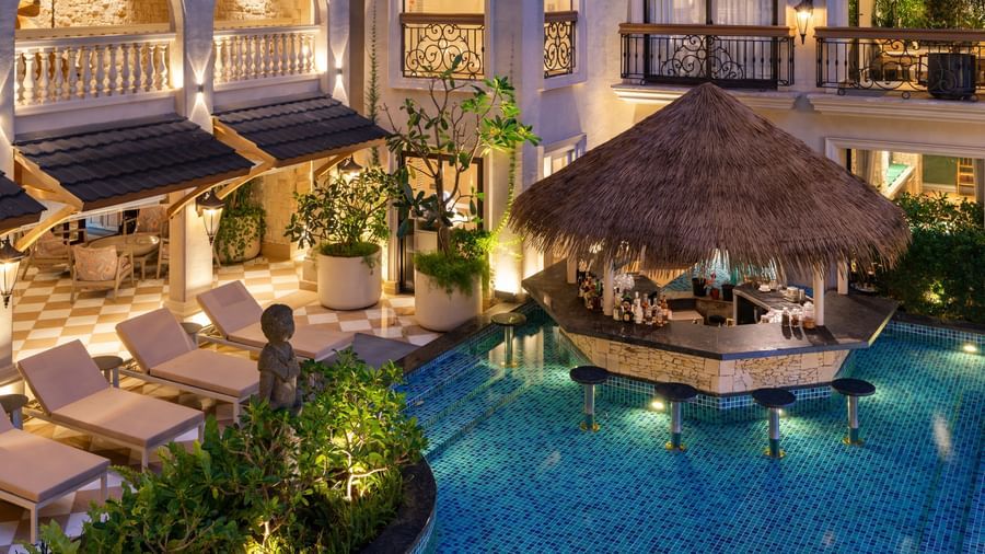 Close-up shot of the Splash Pool Bar featuring a pool-side bar counter cover with thatched roof at The Evren, Vagator.