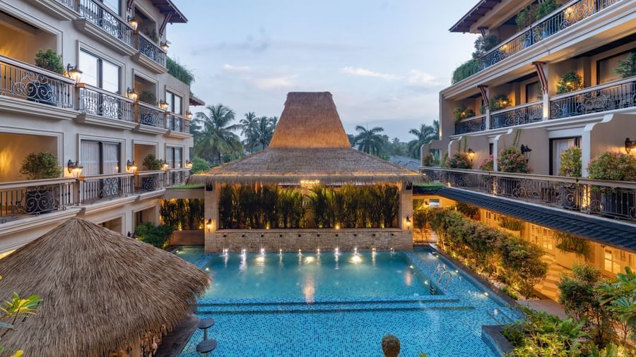 The swimming pool at The Evren, Vagator, between 2 building complexes during the early evening hours.