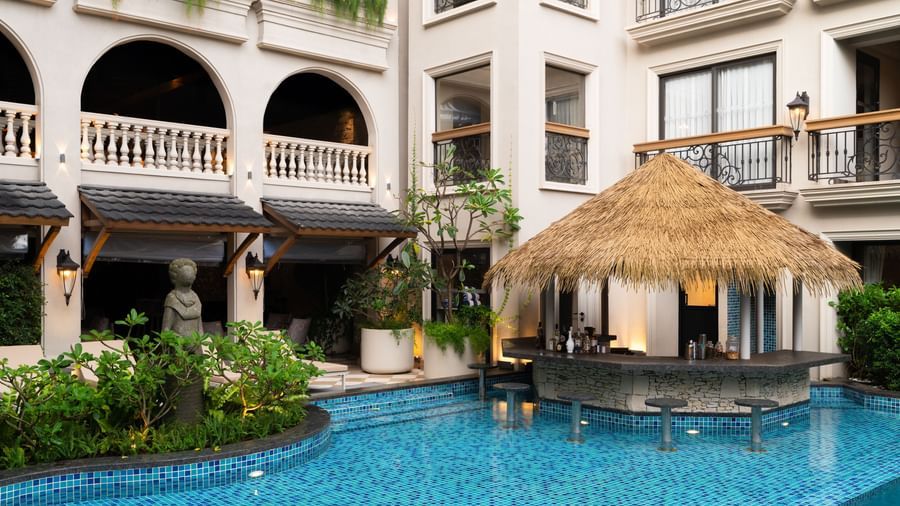 Side-view shot of the Splash Pool Bar with thatched roof above it at The Evren, Vagator.
