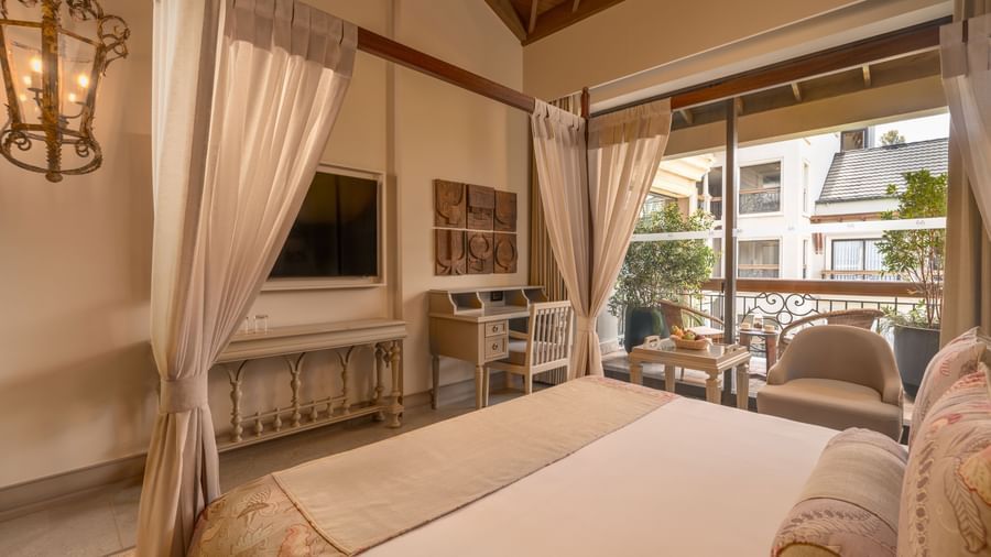Corner view of the Premium Room featuring a double bed and wall-mounted television at The Evren, Vagator.