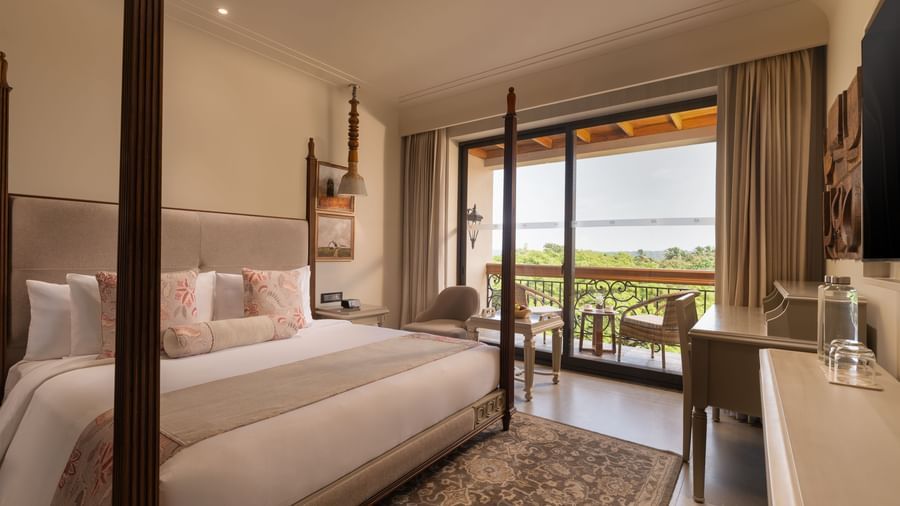 A corner-view shot of the Classic Room (Diwa) featuring a double bed along with a patterned rug placed in front of it at The Evren, Vagator.