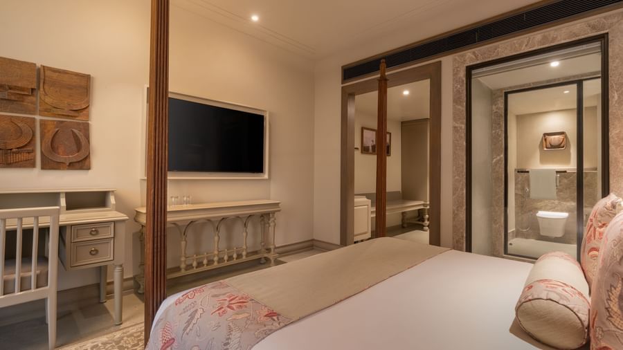 A corner view of the Claasic Room (Diwa) featuring a double bed along with a wall-mounted television in front of it at The Evren, Vagator.