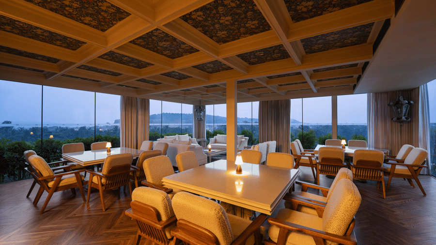 The executive lounge of The Evren with wooden flooring, dining tables, chairs, and open surroundings.