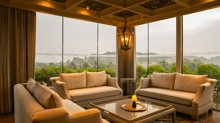 The executive lounge at The Evren with cushioned sofas, a central table, and wooden pillars.