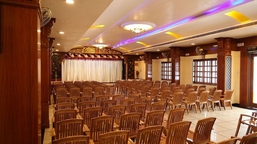corner view image of the banquet hall with a lot of brown coloured chairs arranged at The Grand Krishna Rooms