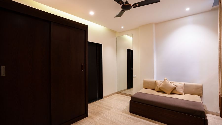 A wide angle shot of the couch in the living room of a spacious accommodation | The Grand Legacy Resort and Spa 