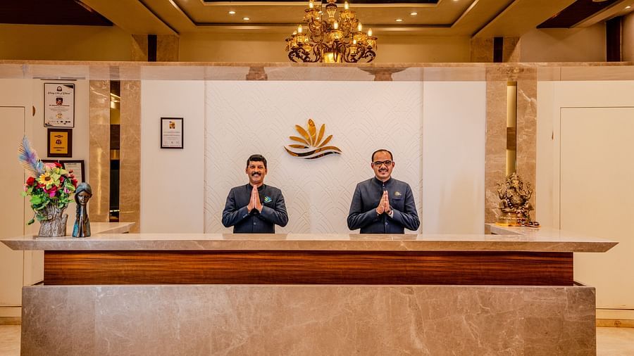 A shot of two staff from the resort welcoming the guest at the reception | The Grand Legacy Resort and Spa