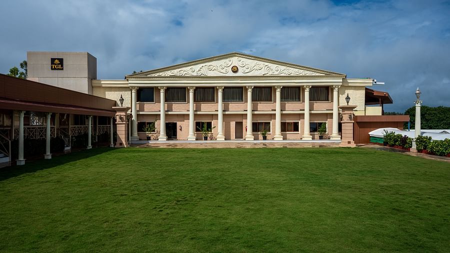 Shot of the lawn with the facade of the hotel in view and a clear sky backdrop