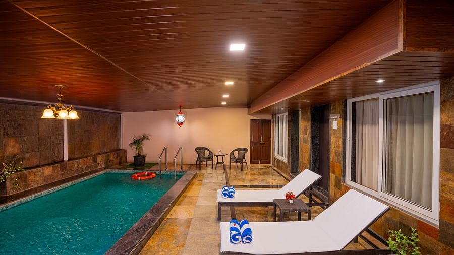 image of a private swimming pool at the resort with two lounge chairs | The Grand Legacy Resort and Spa