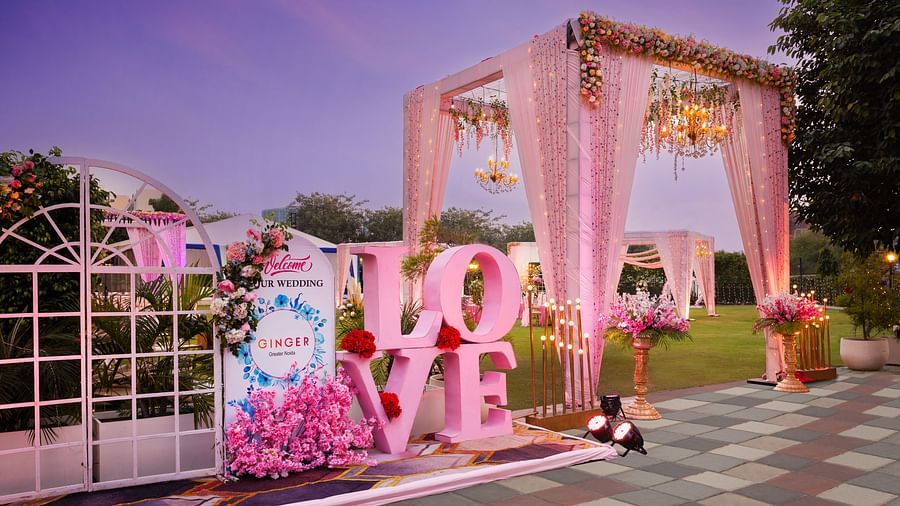 an entrance to an event space with a canopy as the entry and Love written with large letters - The Hideaway Banquets & Lawns, Greater Noida