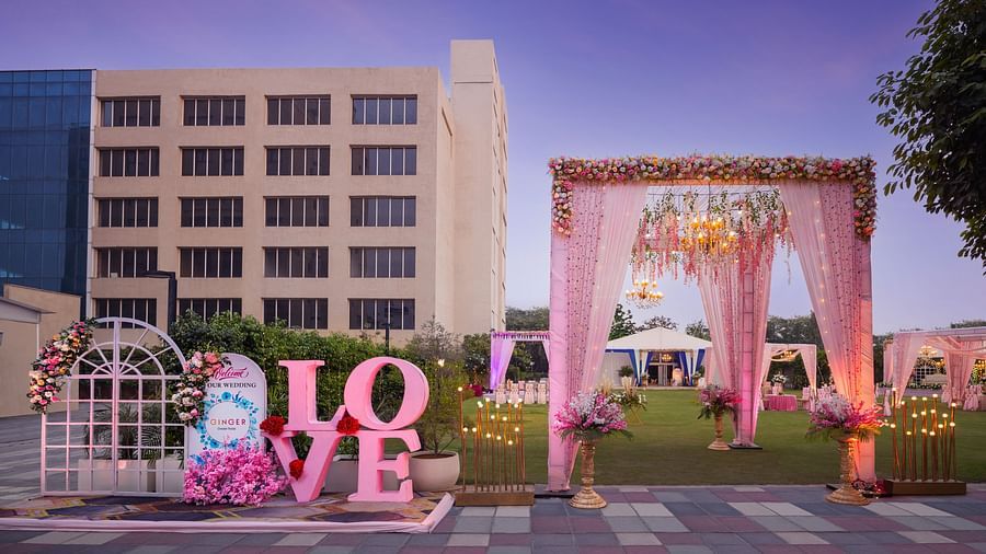 an entrance to an event space with a canopy as the entry and Love written with large letters - The Hideaway Banquets & Lawns, Greater Noida