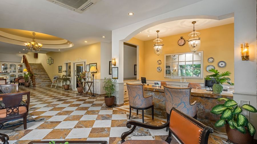 A wide view of the reception of the hotel with chairs and tables in clusters across the room - The Manor, Kashipur