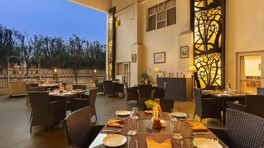 A terrace dining space featuring tables and chairs arranged to offer a beautiful view of the outdoors