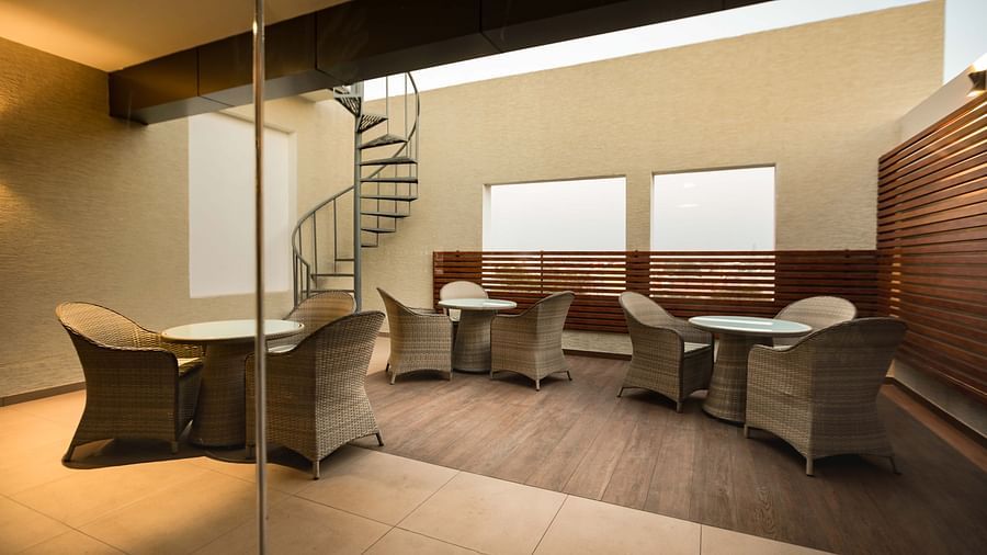lobby with comfortable seating and warm a staircase of The Mayberry, Tiruppur