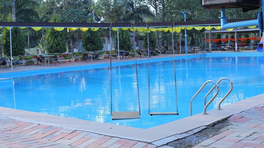 A swimming pool at The Meenakshi Resort by Welcome Inn Hospitality, Bangalore.