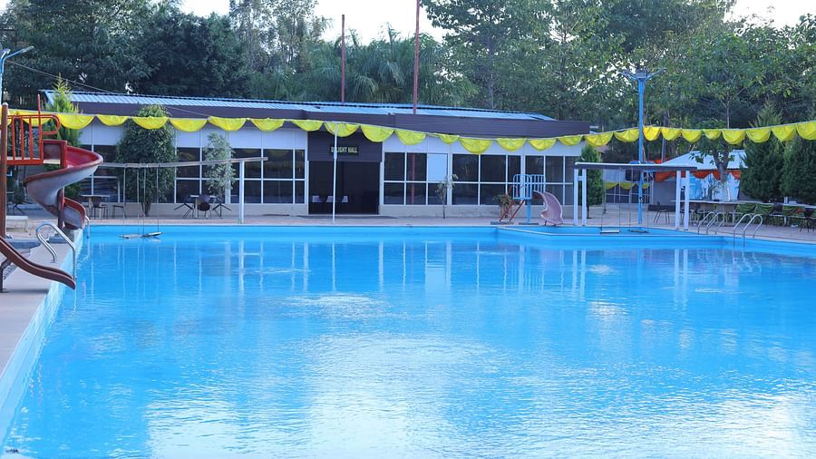 A swimming pool at The Meenakshi Resort by Welcome Inn Hospitality, Bangalore.