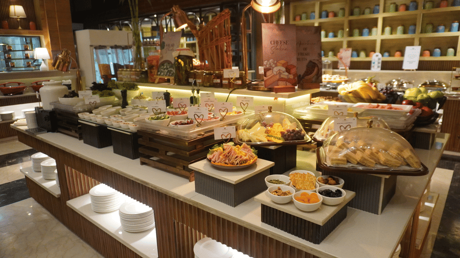 Buffet spread featuring various hot and cold dishes in serving containers  at the Meriton.
