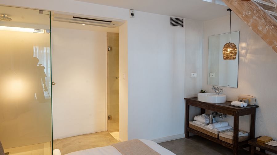 The deluxe loft room washroom area with toiletries and the shower - The Nanee