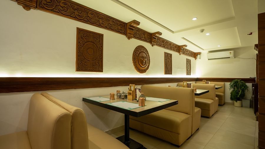 An image of a seating arrangement in a Restaurant at The President Hotel, Hubli